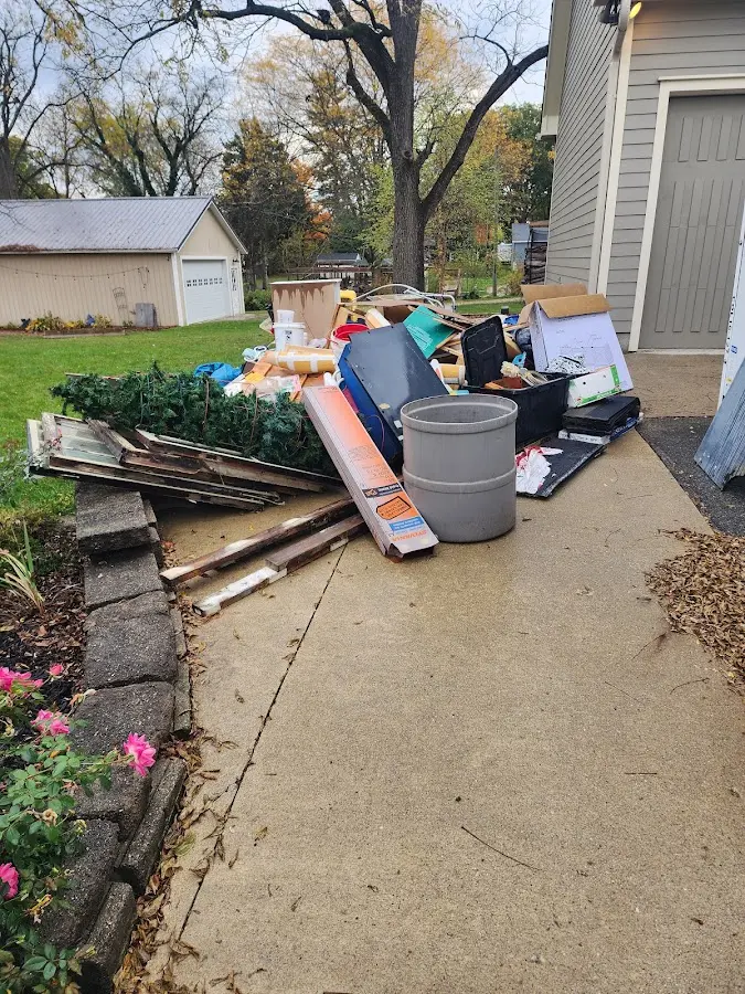 Dumpster being loaded with debris for Residential Dumpster Rental in Pine Bluff
